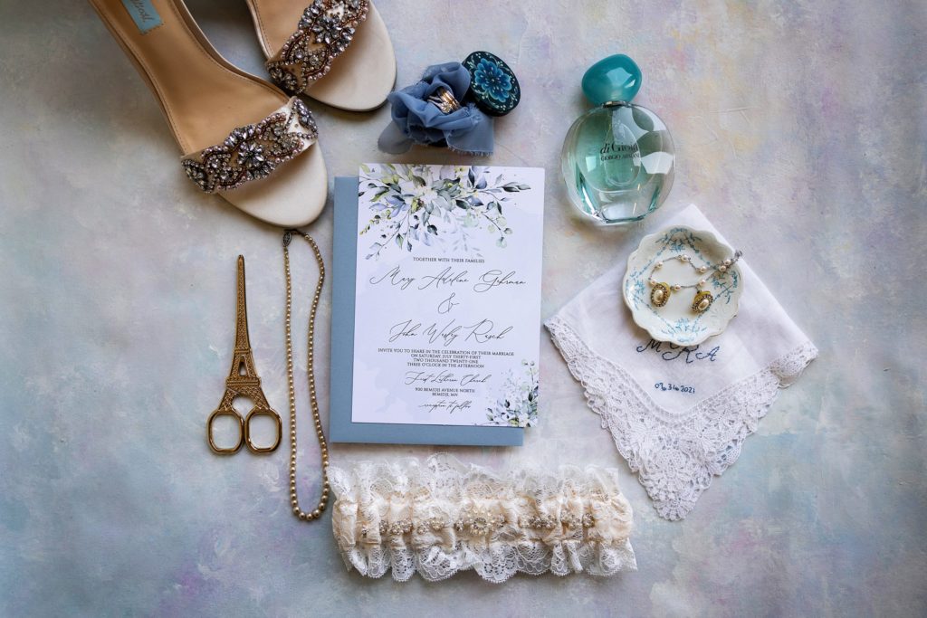flat lay of wedding details including jewelry